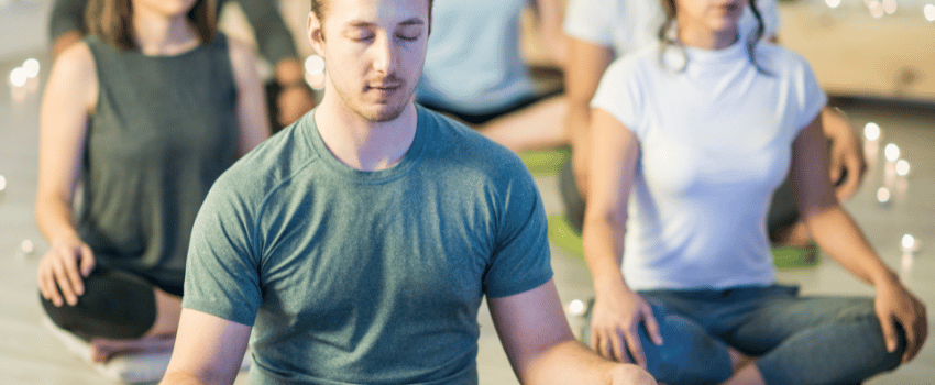 Group of people meditating on the floor